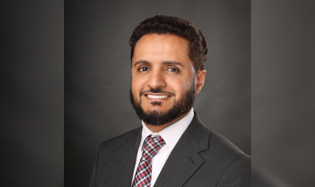 Adam Alharbi, Hamtramck Mayoral candidate, wears a suit and tie.