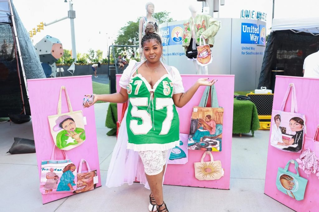 Taylor Childs poses with some of her tote bag designs