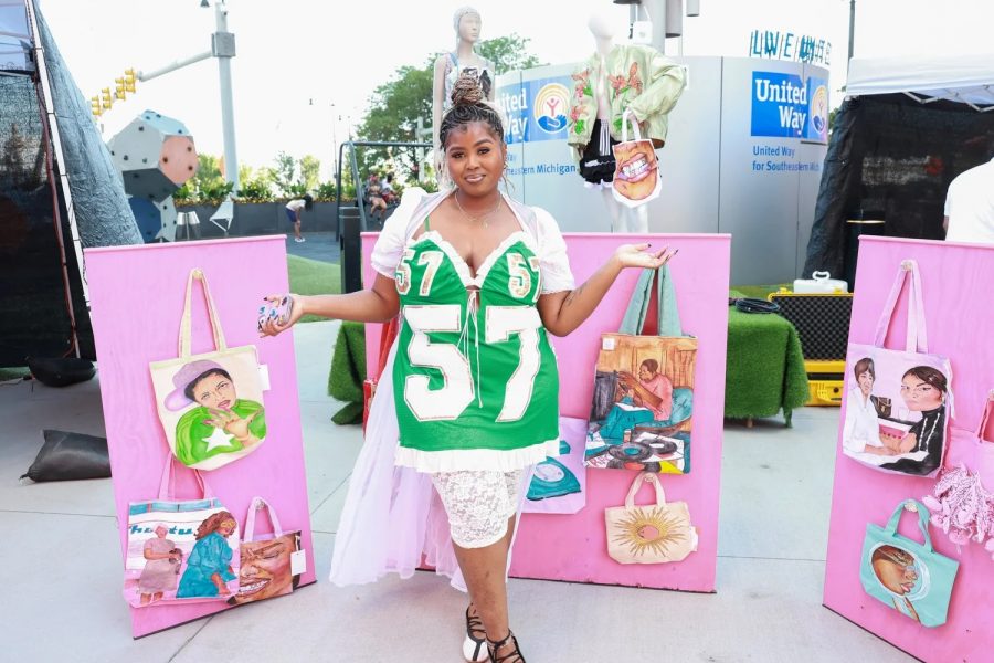 Taylor Childs poses with some of her tote bag designs