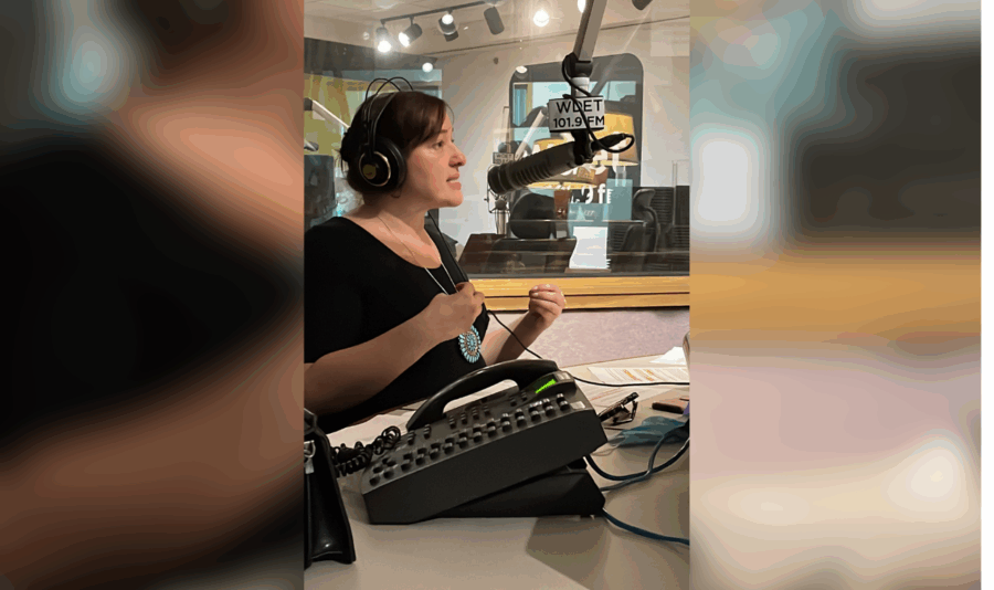 Martina Guzman speaks into a microphone at WDET studios.