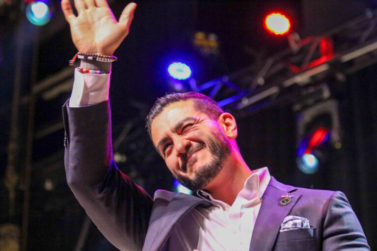 El-Sayed waves in front of stage lights at his campaign rally on Aug. 4, 2026.